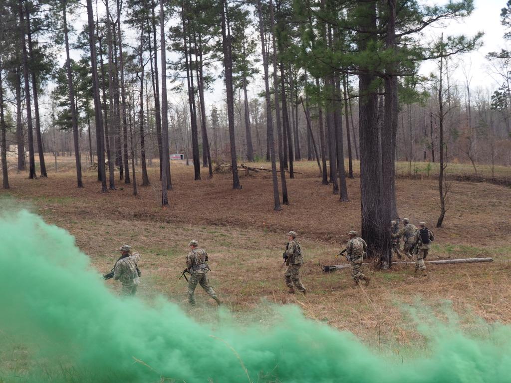 CDTs assaulting across a field under smoke cover