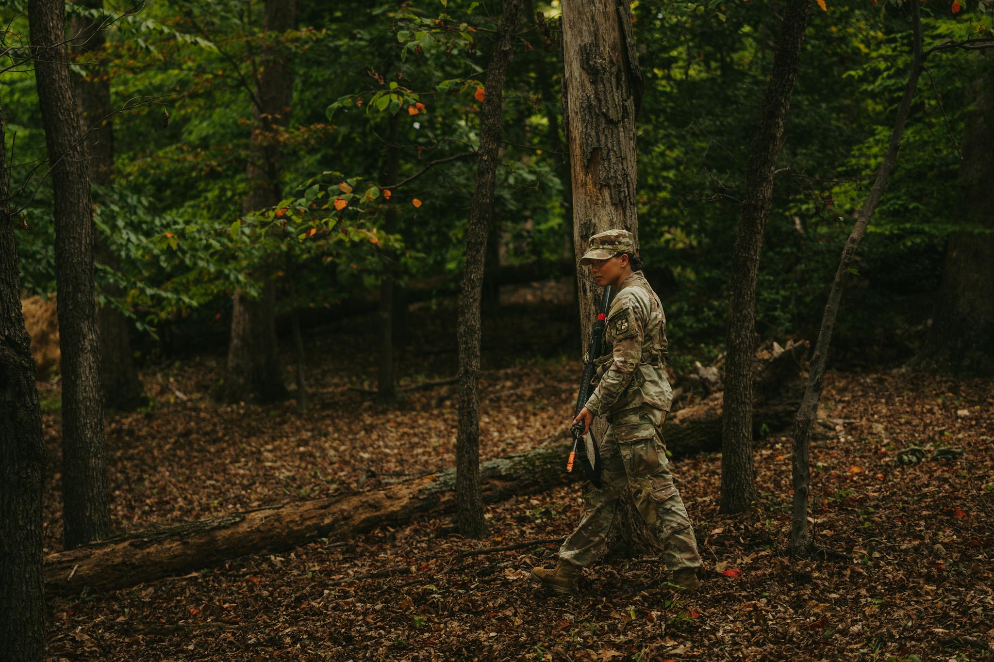 An Army ROTC student participating in a training in the woods